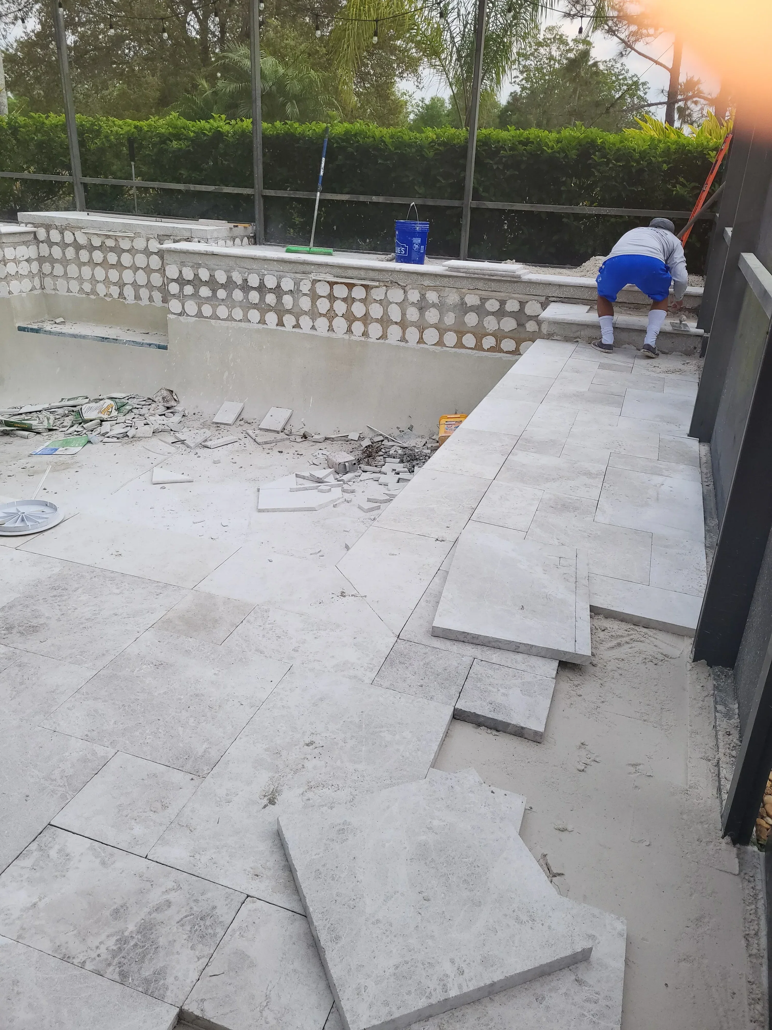 Concrete paver patio installation with drainage base and perforated pipe system